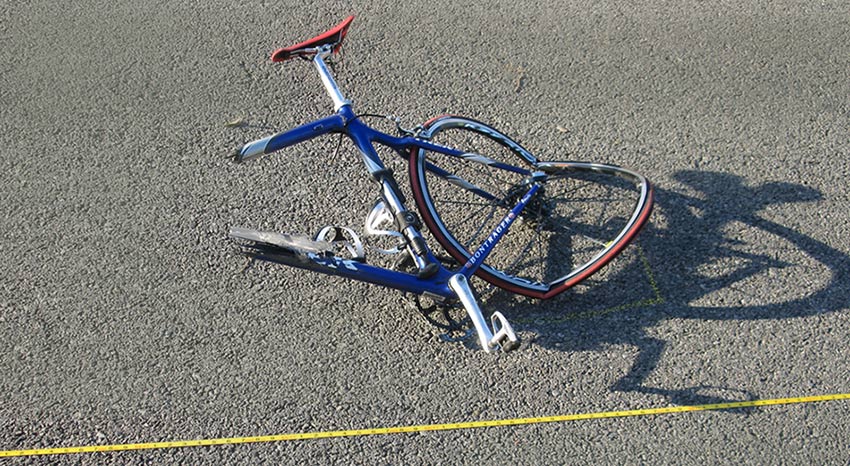 wrecked bicycle in middle of road